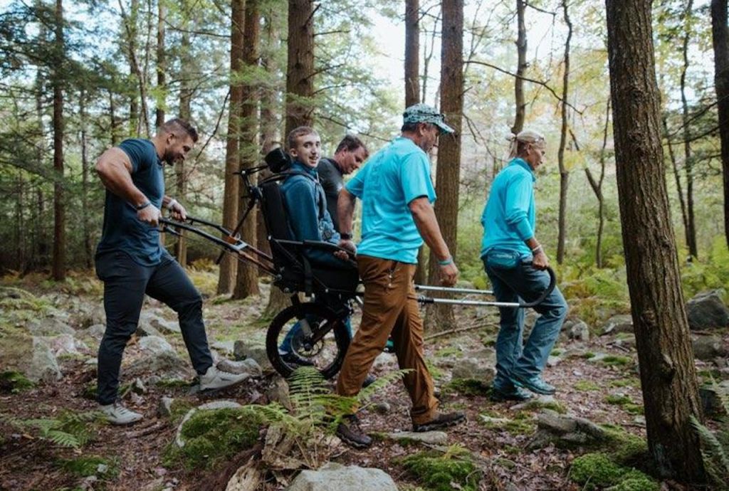 Tim Tebow with chlidren in the forest